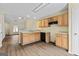 Eat-in kitchen featuring hardwood floors, wood cabinets, and an open layout to the living room at 167 London Dr, Mcdonough, GA 30253