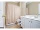 This bathroom features a neutral color scheme, a shower/tub combo, and a white vanity at 110 Camford Stone Path, Fayetteville, GA 30214