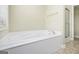 A large white built-in bathtub is the highlight of this bathroom at 110 Camford Stone Path, Fayetteville, GA 30214