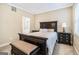 This bedroom features dark wood furniture, neutral walls, and a matching bench at 110 Camford Stone Path, Fayetteville, GA 30214