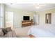 Large bedroom with a flat screen tv, sitting area, and a doorway to a bathroom at 110 Camford Stone Path, Fayetteville, GA 30214