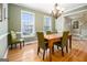 Bright dining room with hardwood floors, modern lighting, and large windows at 110 Camford Stone Path, Fayetteville, GA 30214