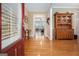Inviting foyer with hardwood floors, a wooden cabinet, and views into the living spaces at 110 Camford Stone Path, Fayetteville, GA 30214