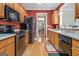Functional kitchen with stainless steel appliances and views into the adjacent dining room at 110 Camford Stone Path, Fayetteville, GA 30214