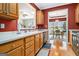 Well-lit kitchen with wood cabinets, views to the dining area, and stainless steel appliances at 110 Camford Stone Path, Fayetteville, GA 30214