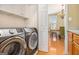 Convenient laundry area near dining room, equipped with modern, stainless steel washer and dryer at 110 Camford Stone Path, Fayetteville, GA 30214
