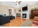 Comfortable living room with hardwood floors, a fireplace, and a ceiling fan at 110 Camford Stone Path, Fayetteville, GA 30214
