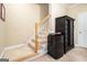 Carpeted staircase with white risers, and a black cabinet with a mini fridge at 110 Camford Stone Path, Fayetteville, GA 30214