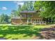 Expansive backyard featuring a spacious deck and mature trees offering shade and privacy at 200 Savannah Walk, Peachtree City, GA 30269