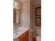 Well-maintained bathroom featuring a classic vanity, mirror, and toilet at 200 Savannah Walk, Peachtree City, GA 30269