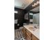 Stylish bathroom with a modern vanity, black walls, and patterned tile floor at 200 Savannah Walk, Peachtree City, GA 30269