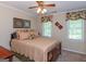Comfortable bedroom with patterned bedspread, soft lighting, and window with floral valance at 200 Savannah Walk, Peachtree City, GA 30269