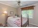 Comfortable bedroom with a decorative quilt, soft lighting, and a ceiling fan at 200 Savannah Walk, Peachtree City, GA 30269
