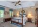 Cozy bedroom features a four-poster bed, soft lighting, and a ceiling fan at 200 Savannah Walk, Peachtree City, GA 30269