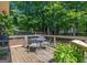 Inviting outdoor deck with seating area and a view of the lush surrounding greenery at 200 Savannah Walk, Peachtree City, GA 30269