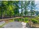 Spacious wooden deck with table set overlooking landscaped yard backed by mature trees at 200 Savannah Walk, Peachtree City, GA 30269