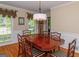 Formal dining room with hardwood floors, wainscoting, and a modern chandelier at 200 Savannah Walk, Peachtree City, GA 30269
