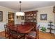 Elegant dining room with hardwood floors, a china cabinet, and modern lighting at 200 Savannah Walk, Peachtree City, GA 30269