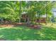 Charming brick home with a lush front yard and mature shade trees at 200 Savannah Walk, Peachtree City, GA 30269