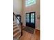 Grand two-story foyer with hardwood floors, staircase, and a front door view at 200 Savannah Walk, Peachtree City, GA 30269