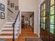 Inviting foyer featuring hardwood floors, staircase, and access to dining at 200 Savannah Walk, Peachtree City, GA 30269