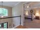 Hallway with hardwood floors, with view to downstairs and primary bedroom at 200 Savannah Walk, Peachtree City, GA 30269
