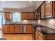Updated kitchen featuring stainless steel appliances, wood cabinets and black countertops at 200 Savannah Walk, Peachtree City, GA 30269