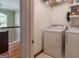 Functional laundry room with white washer, dryer, and storage shelves at 200 Savannah Walk, Peachtree City, GA 30269
