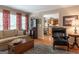 Comfortable living room featuring hardwood floors, and a view to the kitchen and dining area at 200 Savannah Walk, Peachtree City, GA 30269