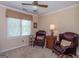 Inviting sitting area with comfortable chairs, soft lighting, and a window at 200 Savannah Walk, Peachtree City, GA 30269