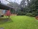 Expansive backyard featuring lush green lawn and mature trees, perfect for outdoor activities at 2071 Scarbrough, Stone Mountain, GA 30088