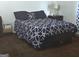 Relaxing bedroom showcasing a comfortable bed with a patterned comforter and a nightstand at 2071 Scarbrough, Stone Mountain, GA 30088
