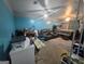 Spacious bedroom featuring seating area and a comfortable bed, illuminated by ceiling fans and natural light at 2071 Scarbrough, Stone Mountain, GA 30088