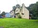 Exterior angled view of home with a well-maintained lawn and a deck at 2071 Scarbrough, Stone Mountain, GA 30088