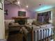 Cozy living room features a stone fireplace, plush seating, and a ceiling fan at 2071 Scarbrough, Stone Mountain, GA 30088