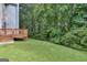 View of the home's backyard, which includes a wooden deck and a lush lawn at 2817 Village Park E Dr, Ellenwood, GA 30294