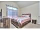 Comfortable bedroom featuring a rustic wood bed frame and dresser, complemented by a soft, neutral color palette at 2817 Village Park E Dr, Ellenwood, GA 30294