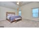 A comfortable bedroom with carpet, a wooden bed, and lots of natural light at 2817 Village Park E Dr, Ellenwood, GA 30294