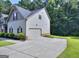 Charming home showcasing light siding, an attached garage, and a well-maintained lawn with a concrete driveway at 2817 Village Park E Dr, Ellenwood, GA 30294