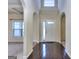 Elegant foyer with hardwood floors, arched doorways, and natural light streaming through the window at 2817 Village Park E Dr, Ellenwood, GA 30294