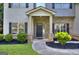 Charming front entrance with a brick facade, complemented by decorative shrubs and a walkway to the front door at 2817 Village Park E Dr, Ellenwood, GA 30294