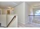 Hallway with carpet, wooden railing, and an arched window providing natural light at 2817 Village Park E Dr, Ellenwood, GA 30294