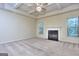 Cozy living room featuring a fireplace, neutral carpet, and large windows for natural light at 2817 Village Park E Dr, Ellenwood, GA 30294