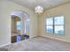 Inviting living room featuring plush carpeting, a decorative chandelier, and an open archway to the main foyer at 2817 Village Park E Dr, Ellenwood, GA 30294