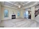 Inviting living room with plush carpeting, fireplace, coffered ceiling, and open access to the kitchen and staircase at 2817 Village Park E Dr, Ellenwood, GA 30294