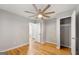 Bedroom with hardwood floors, large ceiling fan, and ample closet space at 1737 Cahoon Sw St, Atlanta, GA 30310