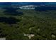 Aerial shot showing property surrounded by trees; a nearby school and neighborhood hint at a community setting at 360 Darren Dr, Fayetteville, GA 30215