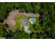 Aerial view showcases home with pool, lush landscaping, private driveway, and nestled amongst trees, a true oasis at 360 Darren Dr, Fayetteville, GA 30215