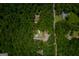 Aerial view reveals home with pool nestled amongst trees, with nearby homes, offering both privacy and community at 360 Darren Dr, Fayetteville, GA 30215