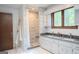Bathroom featuring double sinks, a tiled shower, and a decorative wooden ladder at 360 Darren Dr, Fayetteville, GA 30215